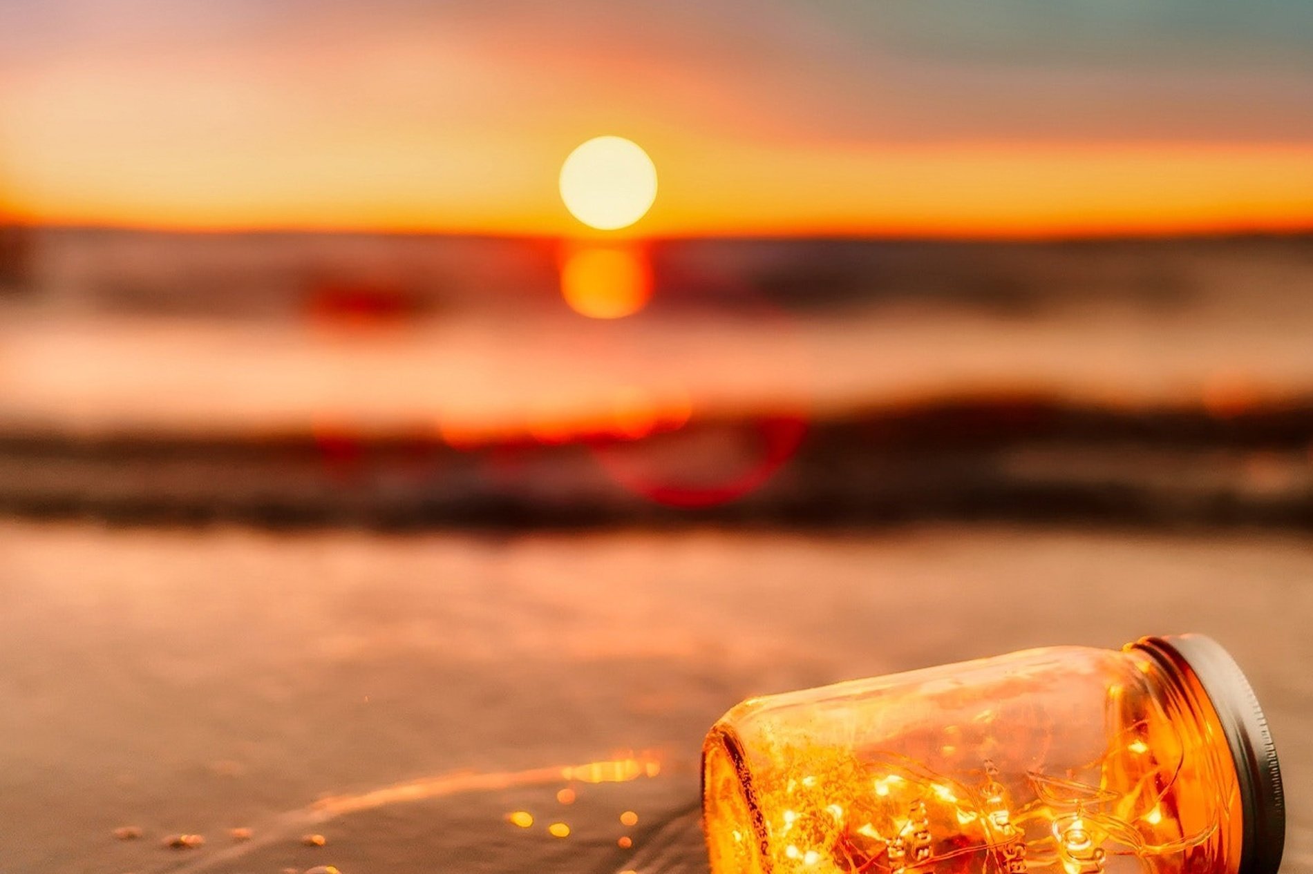 a woman sitting on a beach chair looking at the sun