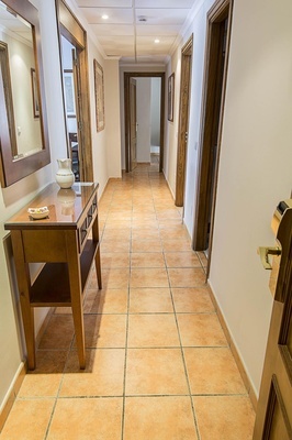 a hallway with a table and a vase on it