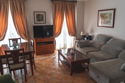 a living room with a couch a table and a television