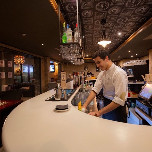 a bartender prepares a drink in a restaurant