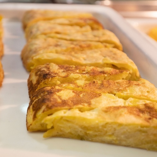 a row of omelet slices on a white plate