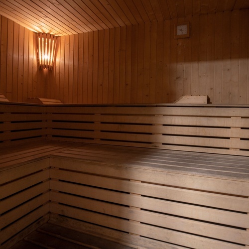 a wooden sauna with a clock on the wall
