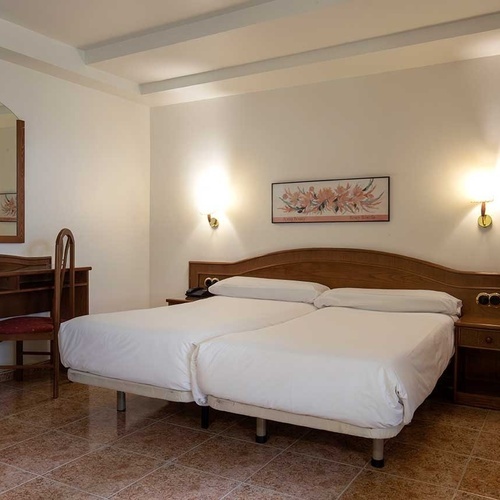 a hotel room with a bed and a chair