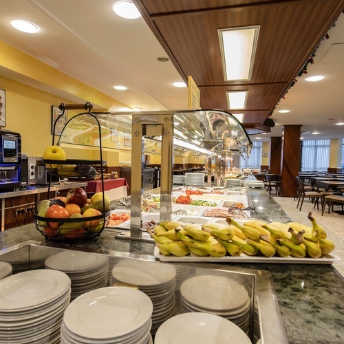 a buffet with a basket of fruit and a bunch of bananas