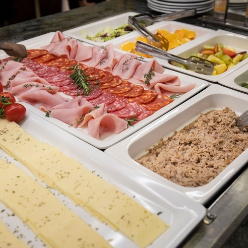 a buffet with a variety of meats and cheeses