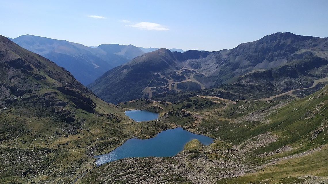 a view of a mountain range with two lakes in the foreground