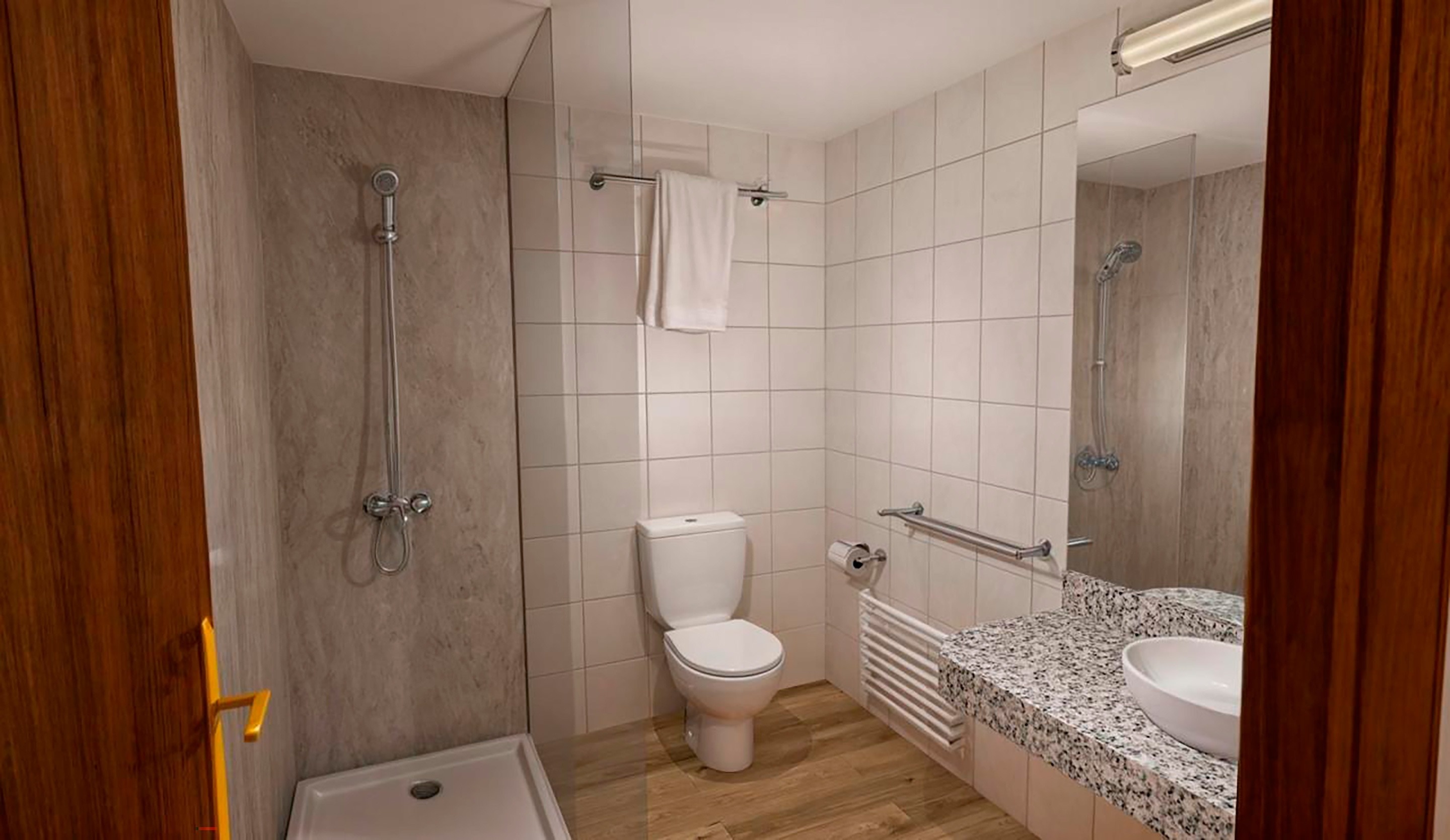 a bathroom with a toilet a sink and a shower