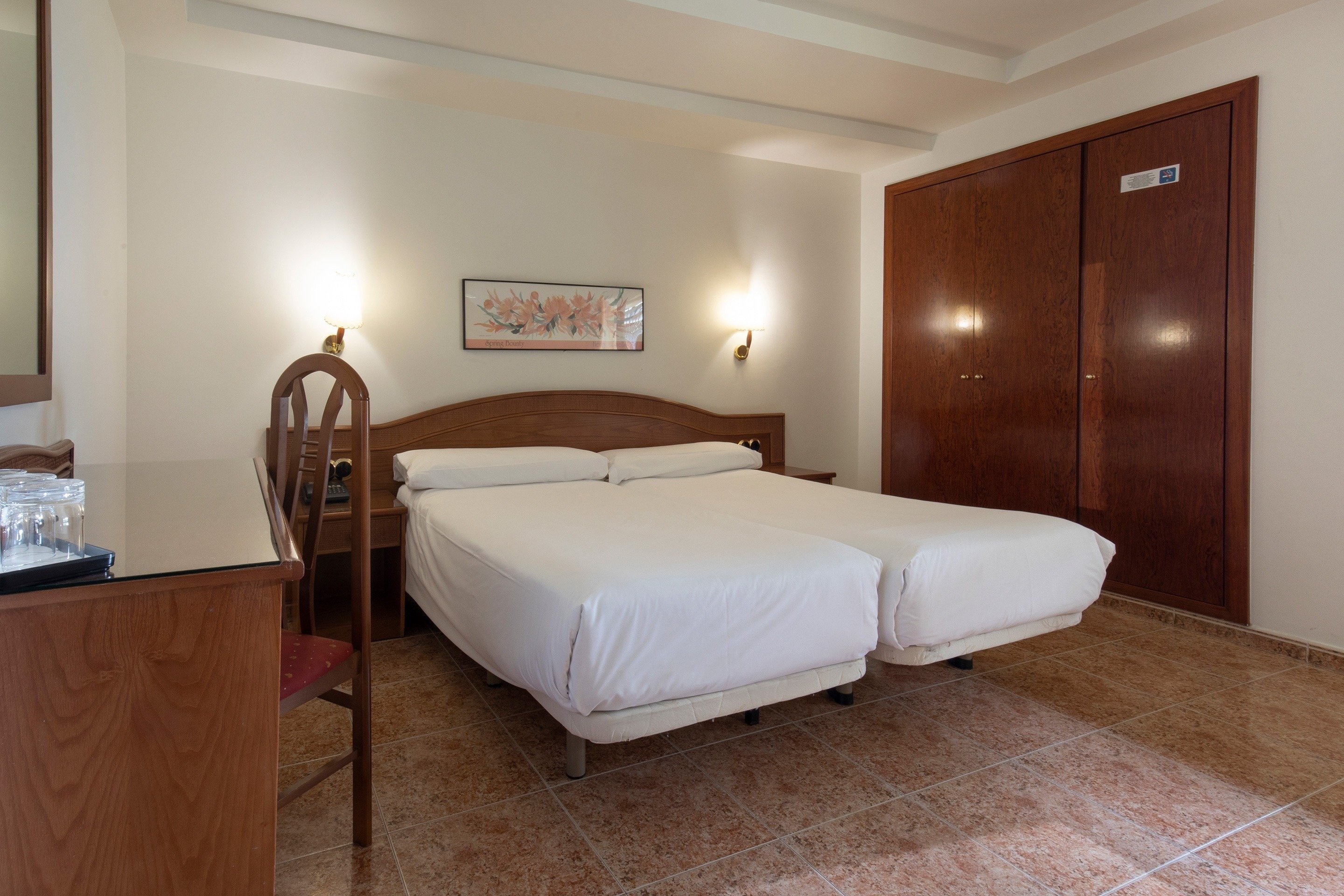 a hotel room with two beds and a sign that says ' a ' on it
