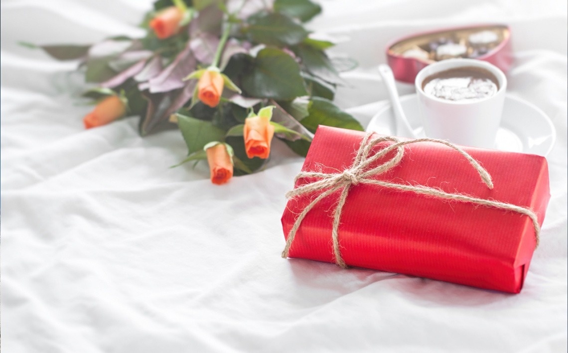 strawberries in a martini glass next to two glasses of champagne