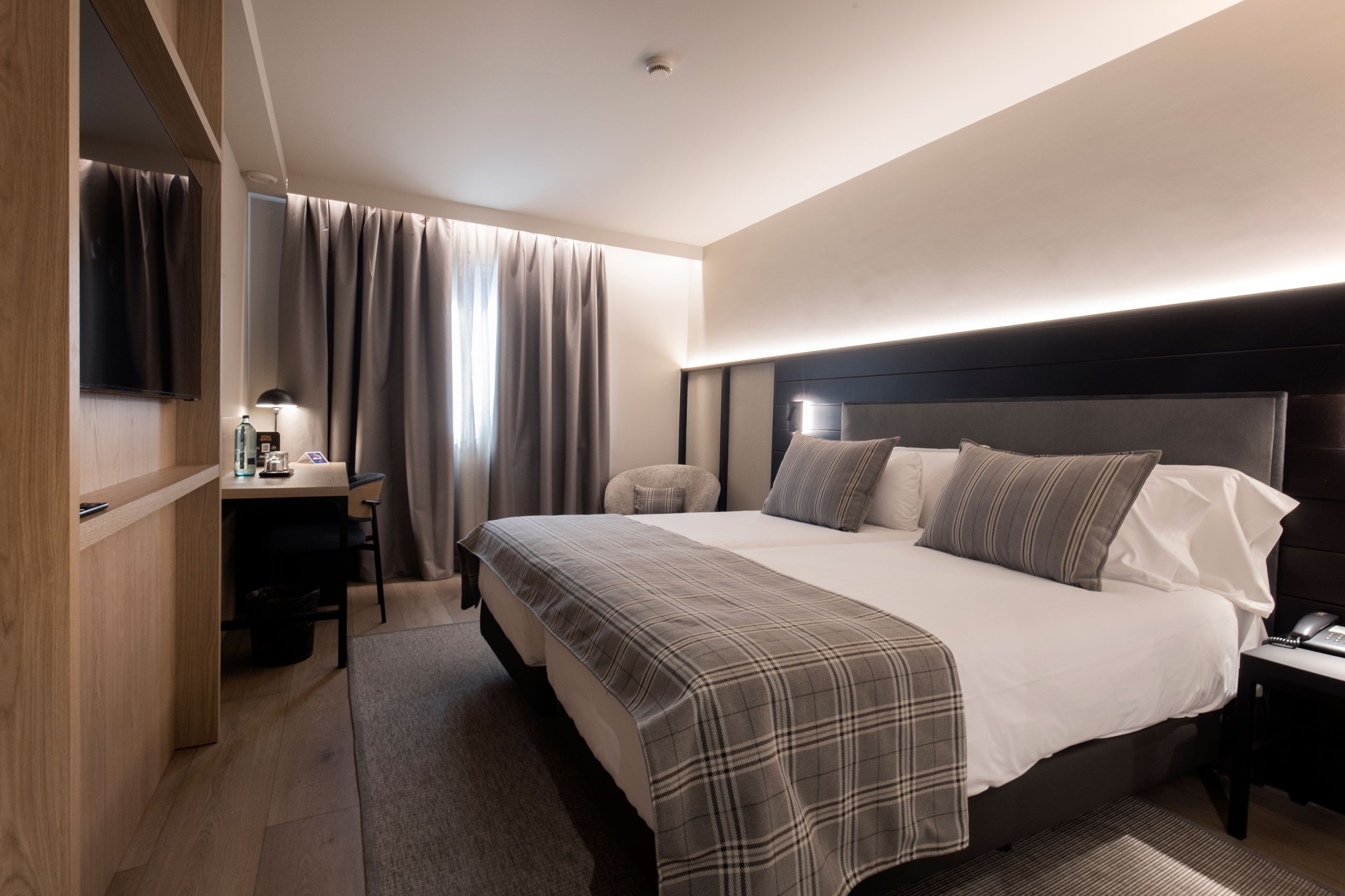 a hotel room with two beds and a desk
