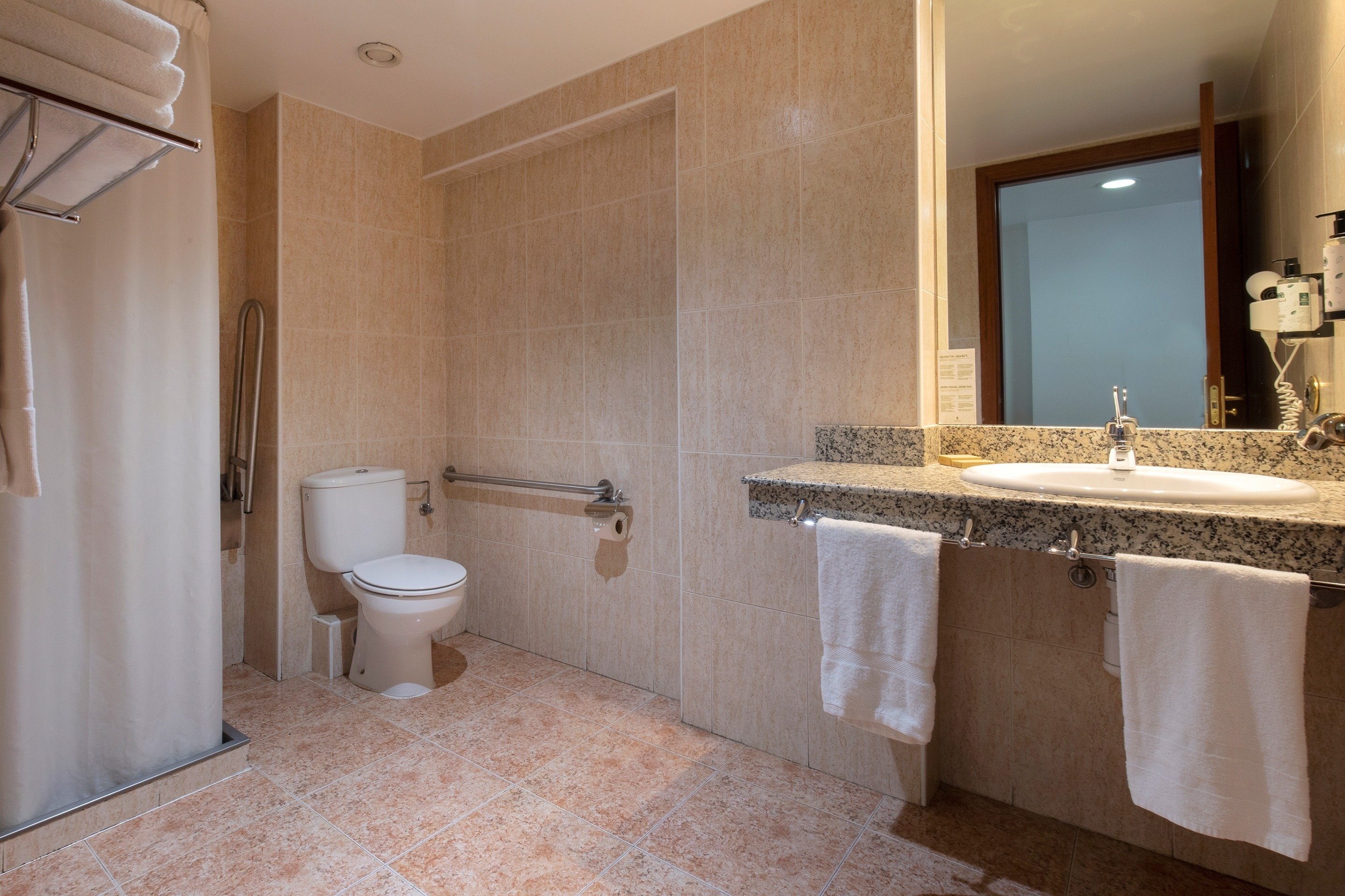 a bathroom with a toilet a sink and a mirror