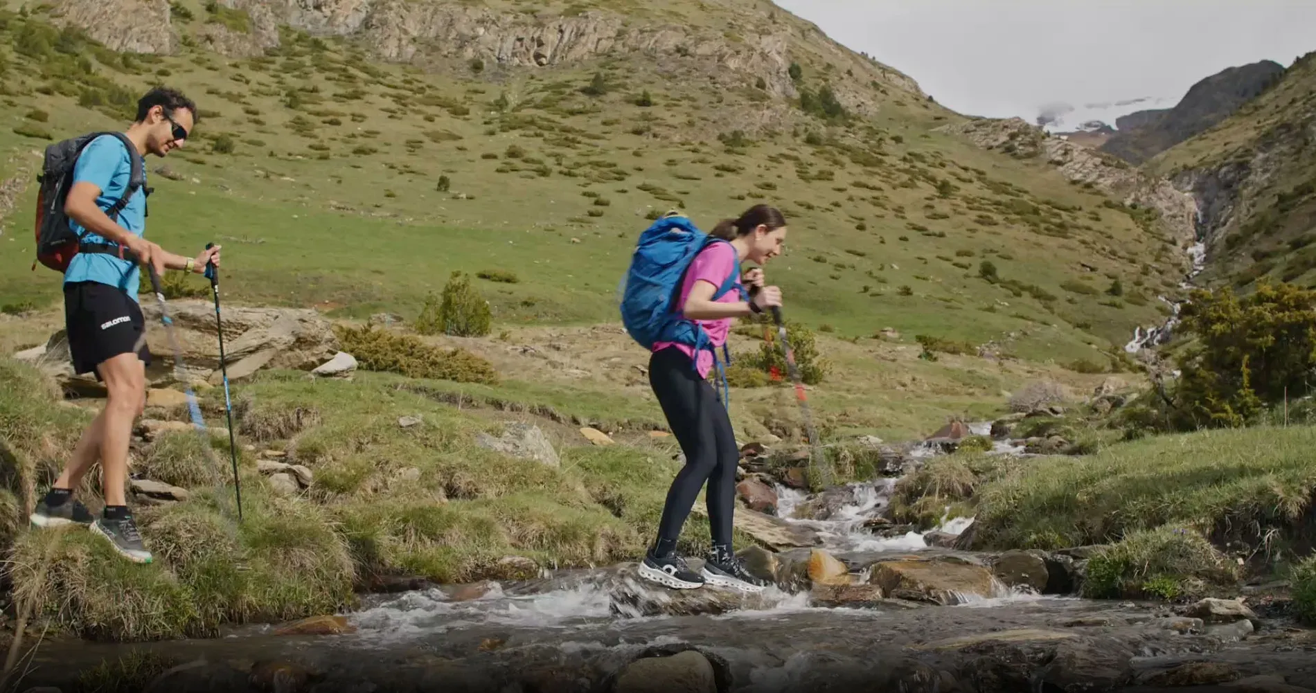 NEXTA: Corporate - Hikers crossing mountain stream, Hiking and adventure.