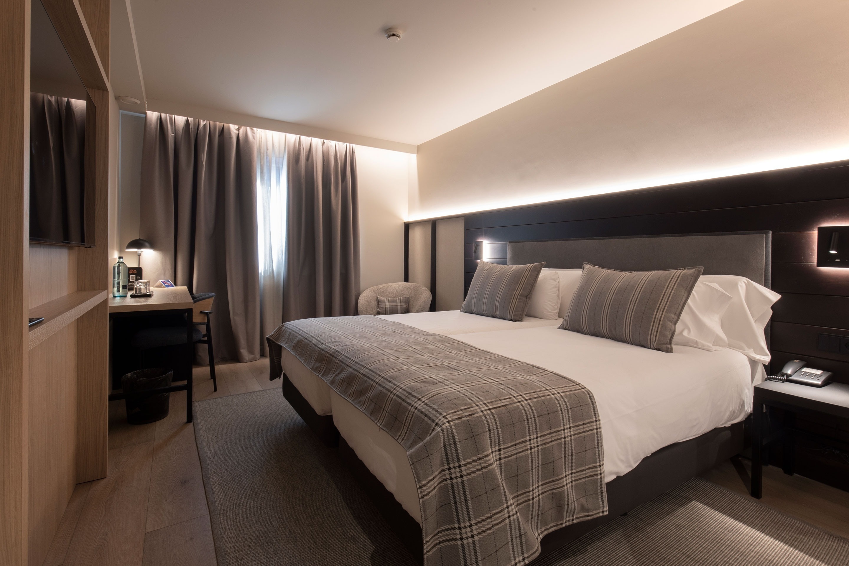 a hotel room with a large bed and a desk