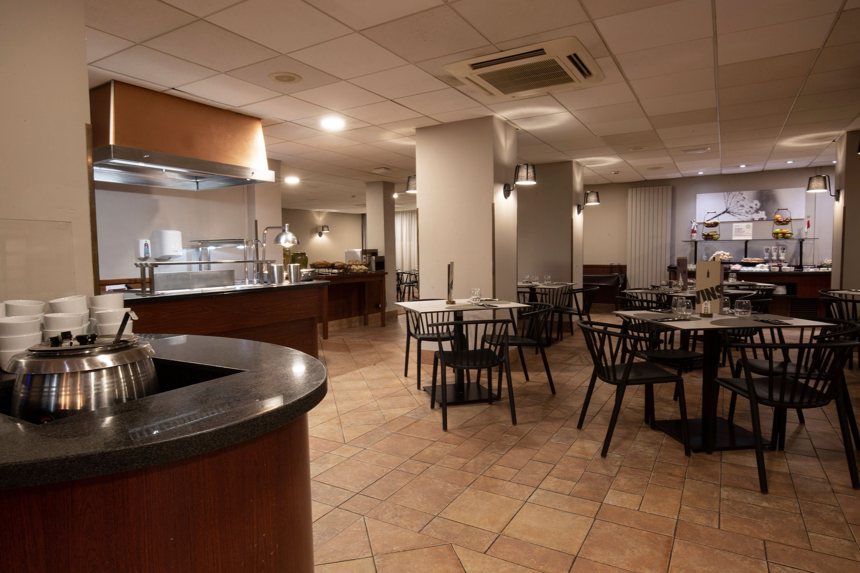 a restaurant with tables and chairs and a buffet