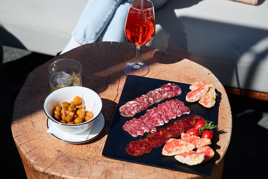 a plate of food on a table next to a glass of wine