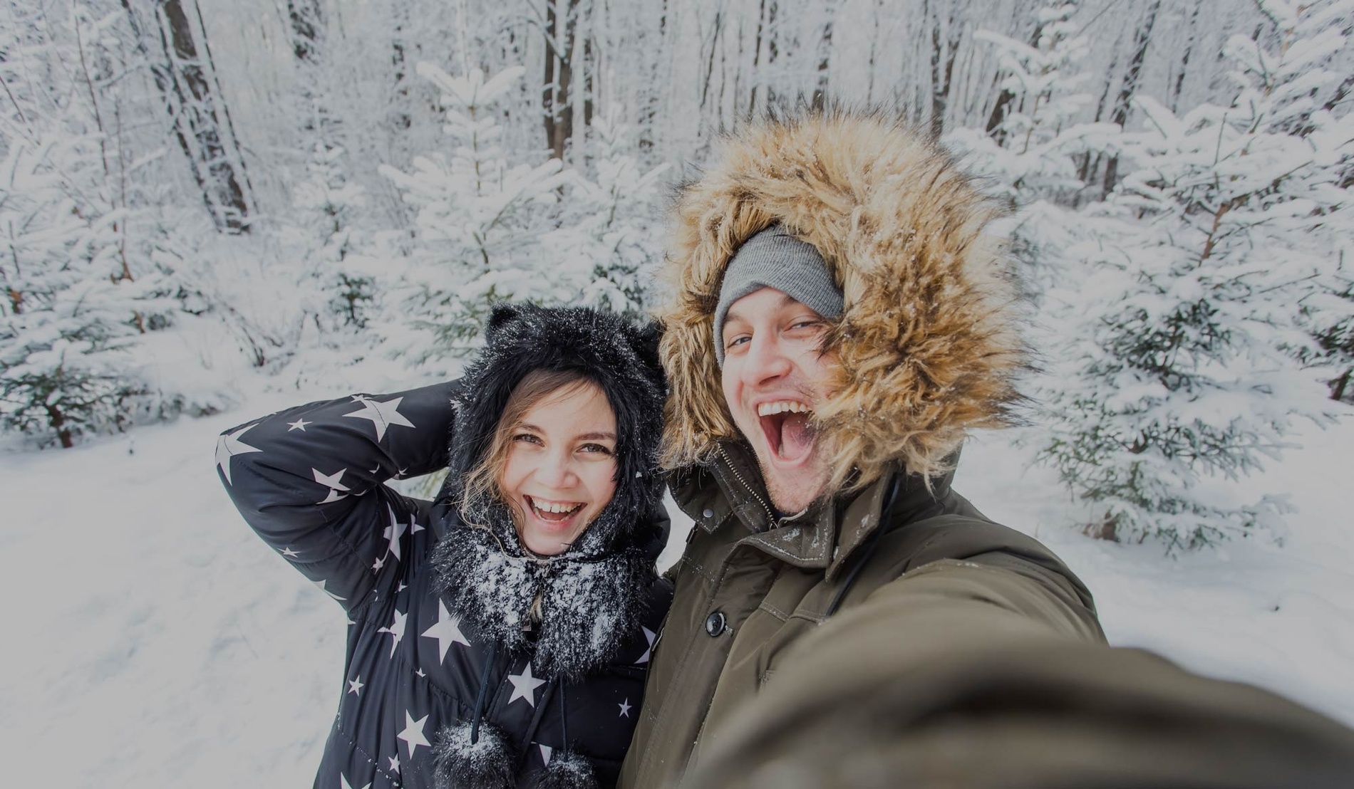 a woman wearing a straw hat stands in front of a blue and white striped building