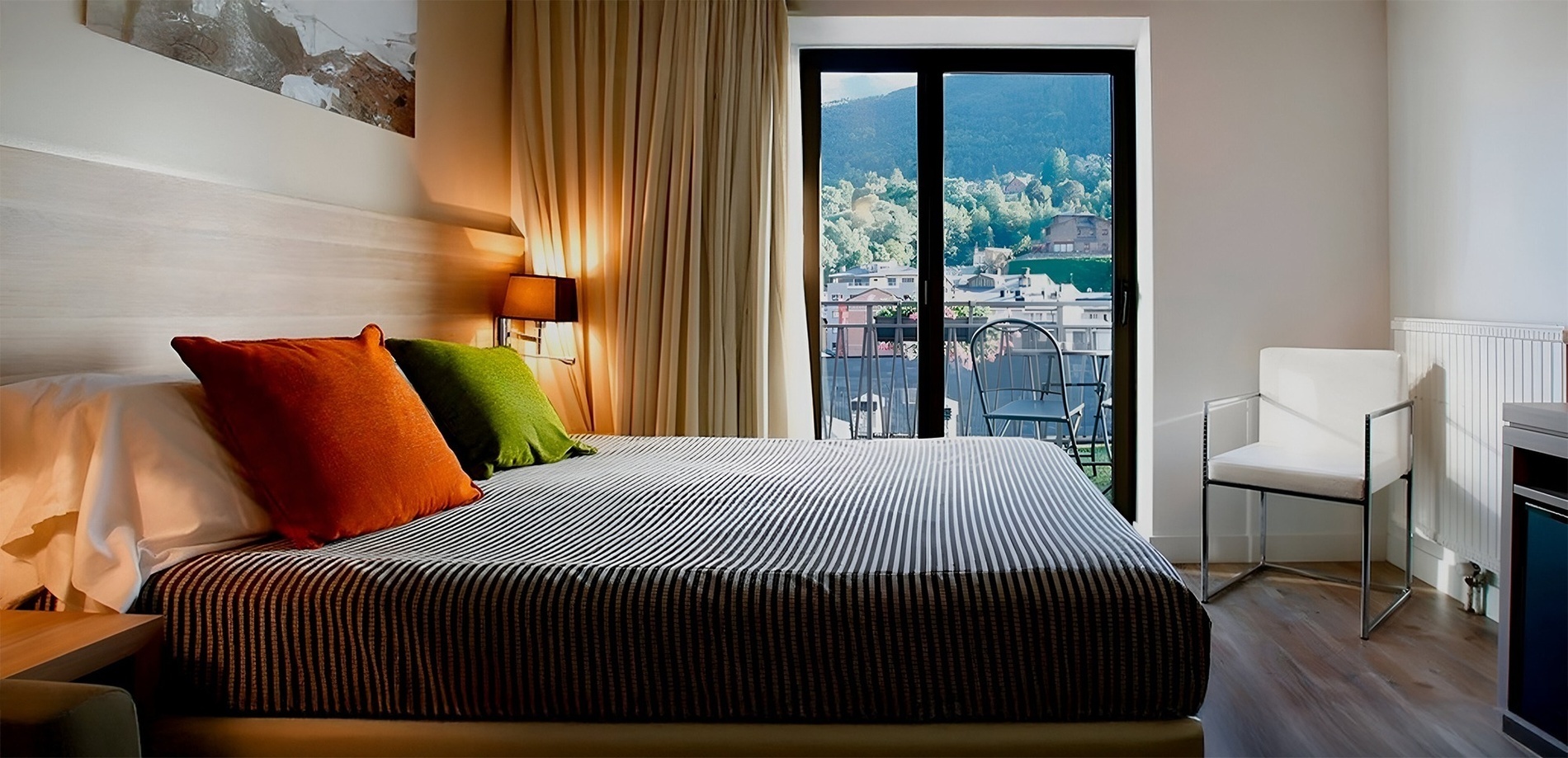 a hotel room with a striped bed and a chair