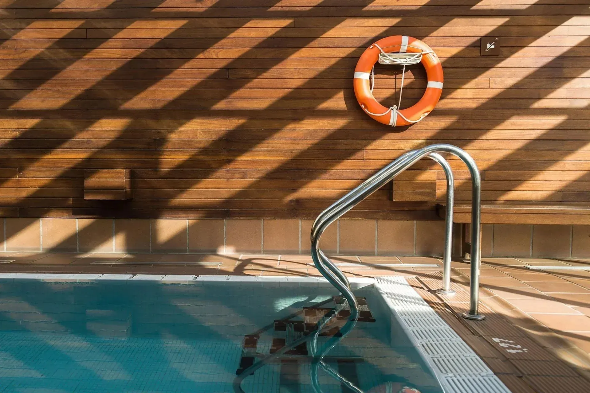 people are swimming in a large pool with a sign that says ' eau thermale ' on it