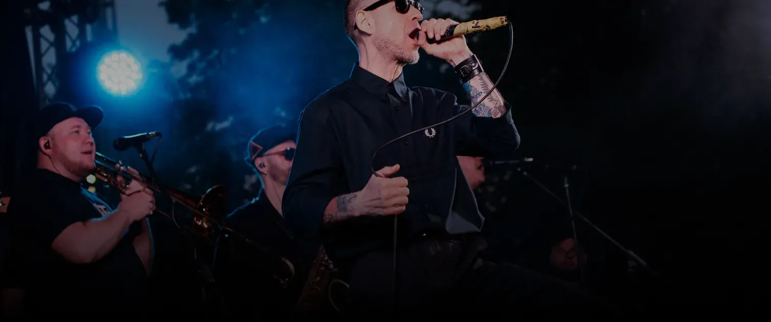 NEXTA: Corporate live band, performing energetically under neon lights.