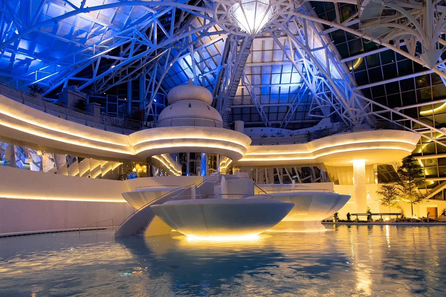 NEXTA: Corporativa indoor pool with futuristic design and blue LED lighting.