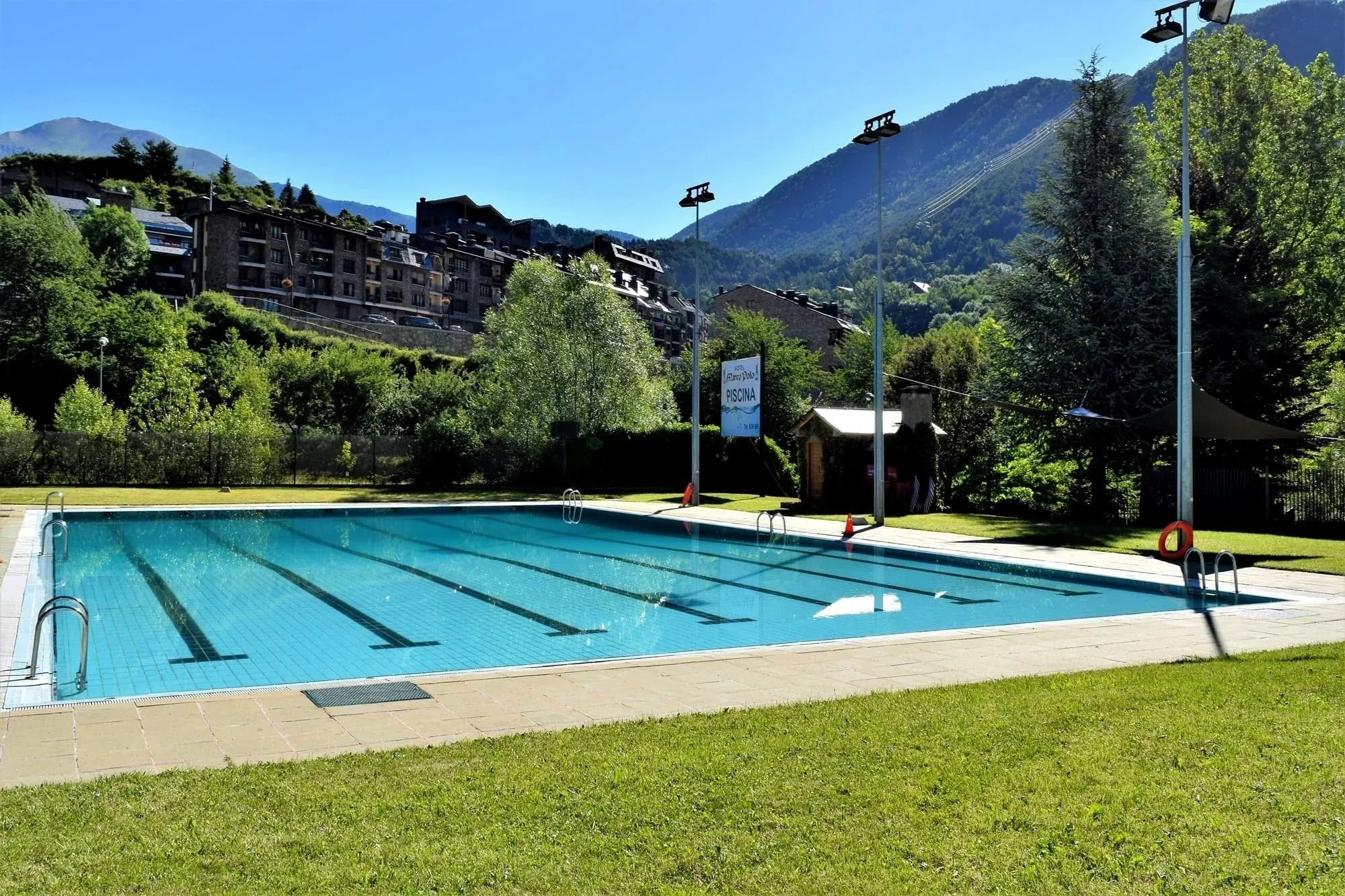 people are swimming in a large pool with a sign that says ' eau thermale ' on it