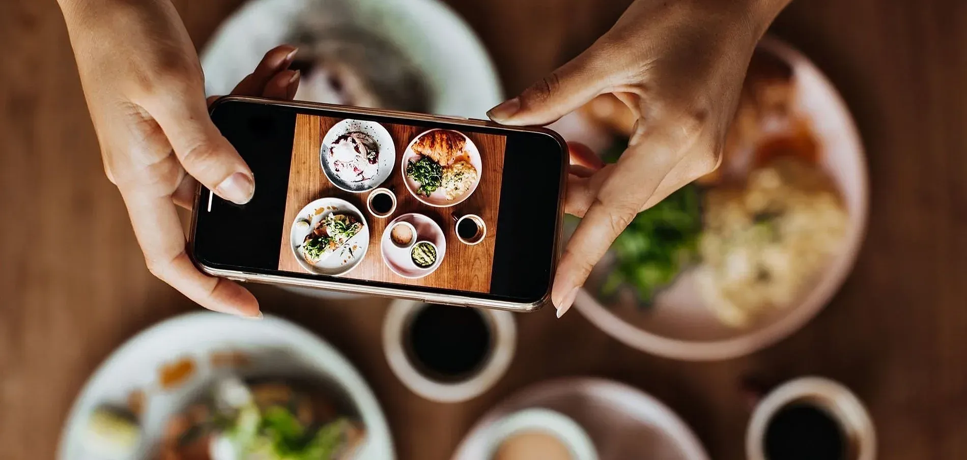 Savor the culinary delights of Andorra: a phone captures a vibrant meal at Savor Experience | Nexta Official Website.