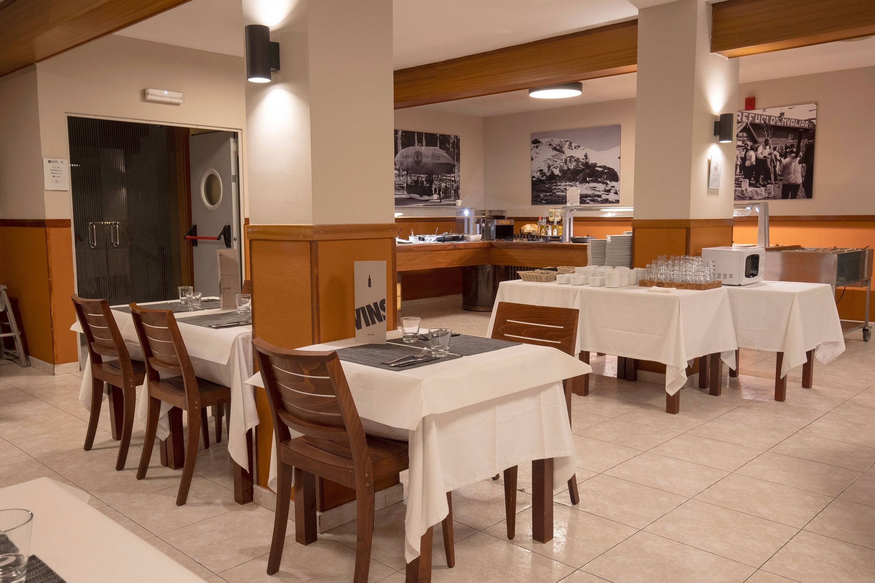 a restaurant with tables and chairs and a sign that says wine