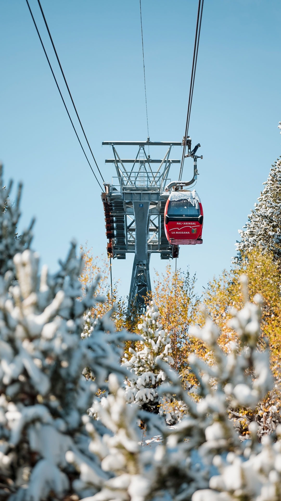 a red ski lift going up a snowy mountain