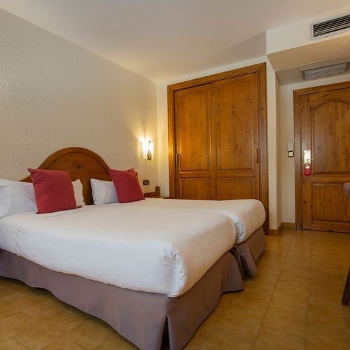 a hotel room with two beds and a desk