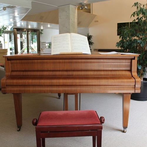 a piano with a book of music on top of it