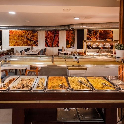 a buffet line in a restaurant with many different types of food