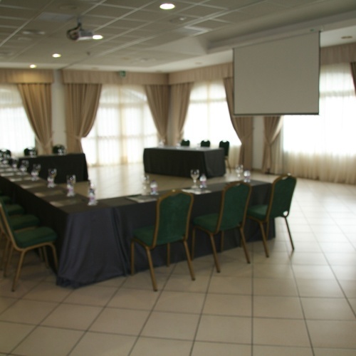 a large room with tables and chairs set up for a meeting