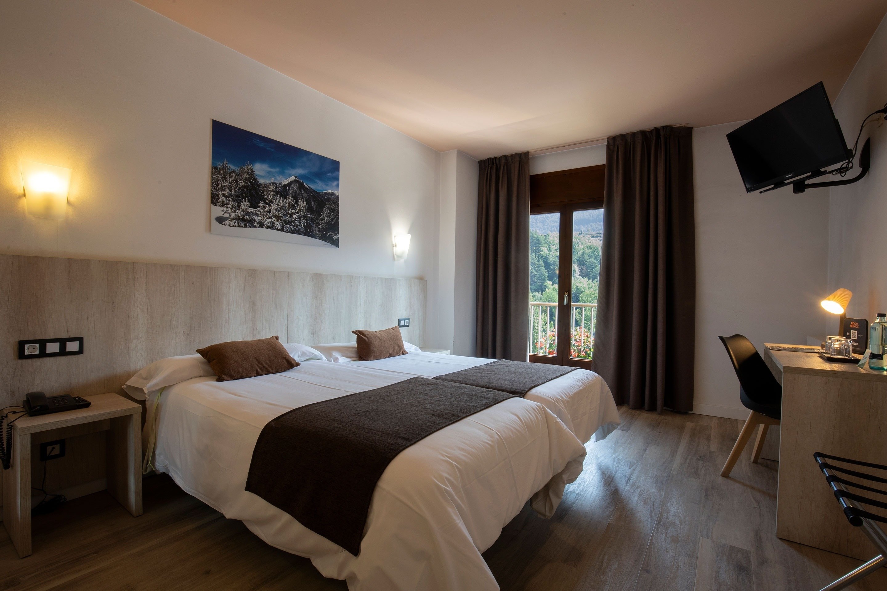 a hotel room with two beds and a television