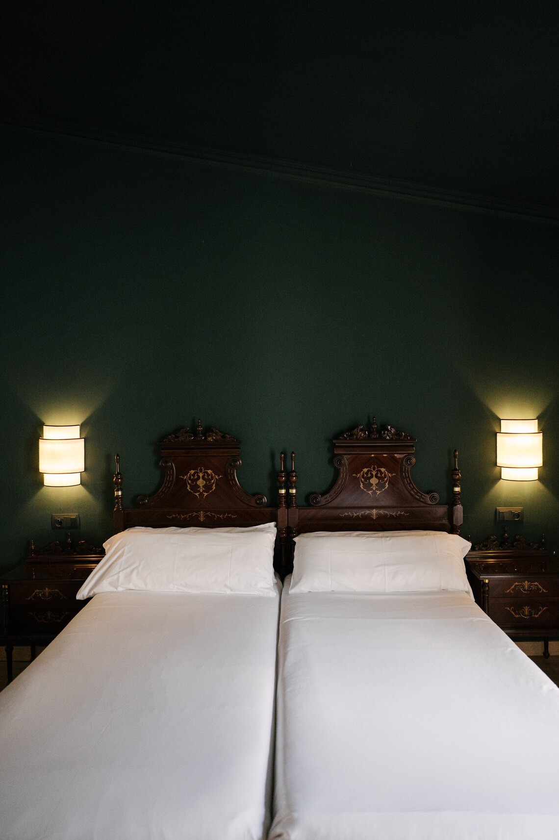 Spacious room with born carved wood bed and classic furniture.