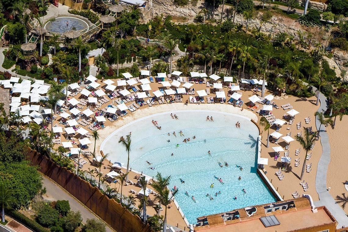 kobieta siedzi przy stole, jedząc makaron i pijąc wino