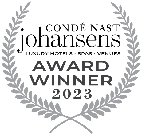 En grå lagerkrans med texten "Condé Nast Johansens Award Winner 2023".