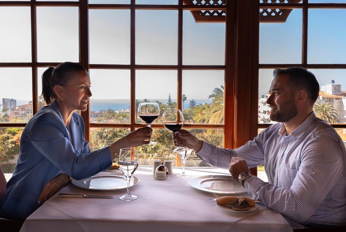 a man sits in a hot tub with his arms outstretched