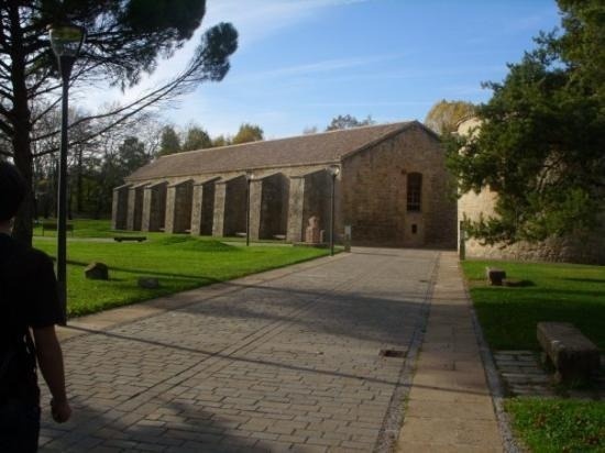 a brick walkway leads to a large stone building