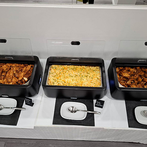 Salão de eventos do Hotel Monaco com mesas postas e decoração vermelha.