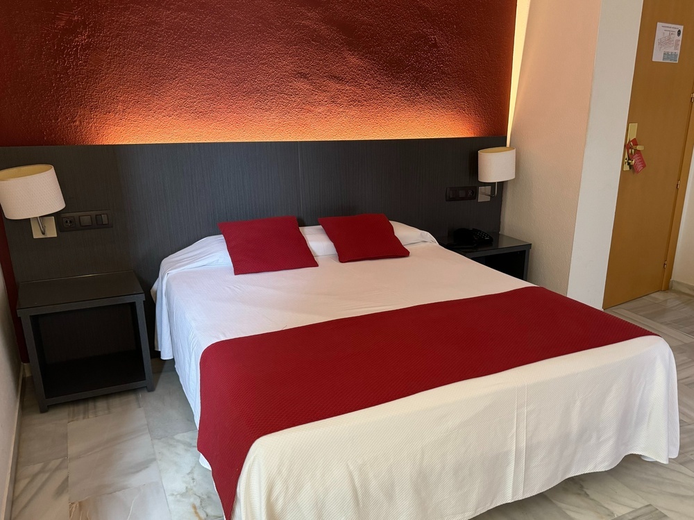 a hotel room with a bed and two nightstands