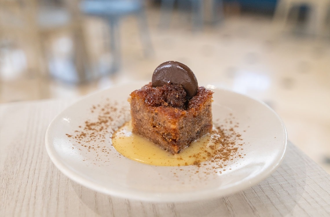 a white plate with a piece of cake on it