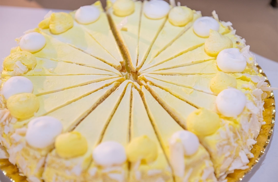 a yellow cake with white frosting and marshmallows on top