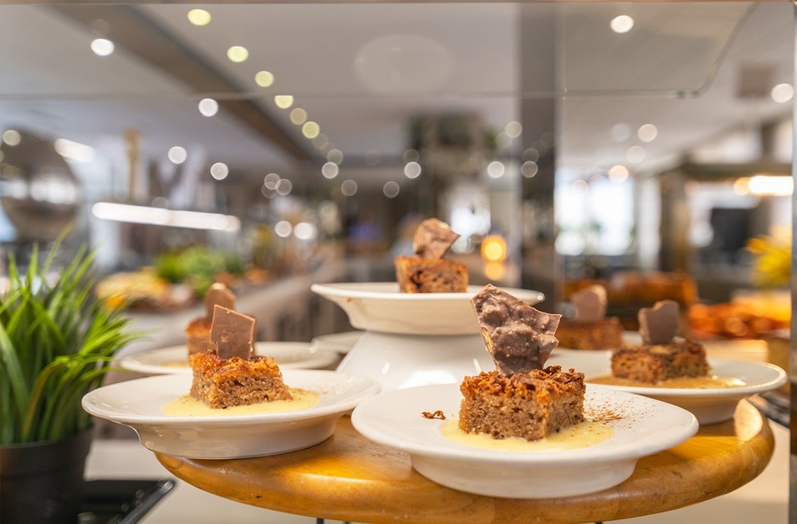 a display of desserts with a plant in the background