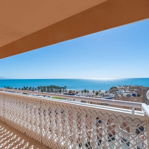 a balcony overlooking the ocean with a white railing