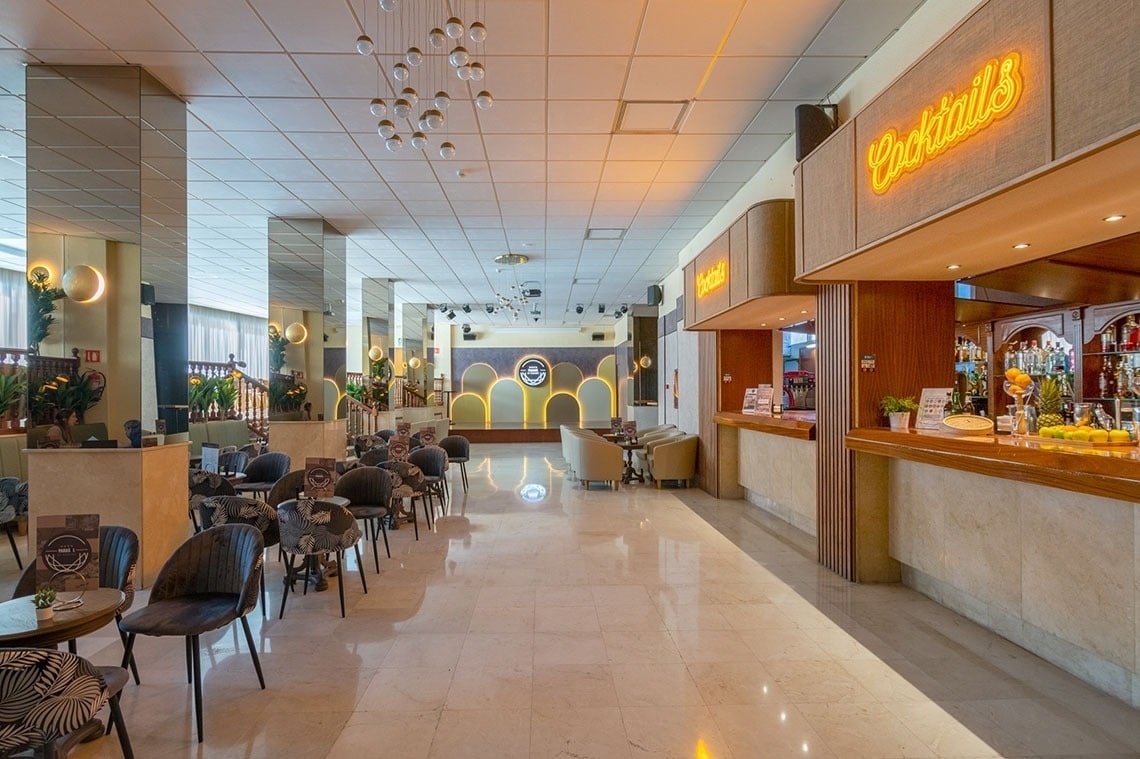 a large room with a bar and a sign that says cocktails