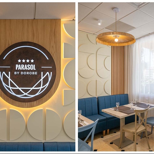 La imagen muestra un ambiente interior moderno de restaurante con un letrero circular retroiluminado de 