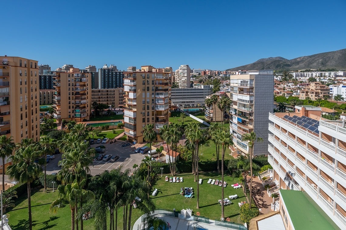 an aerial view of a city with lots of buildings and palm trees