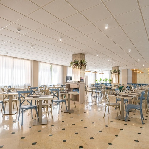 a large dining room with tables and chairs and a sign that says cafe