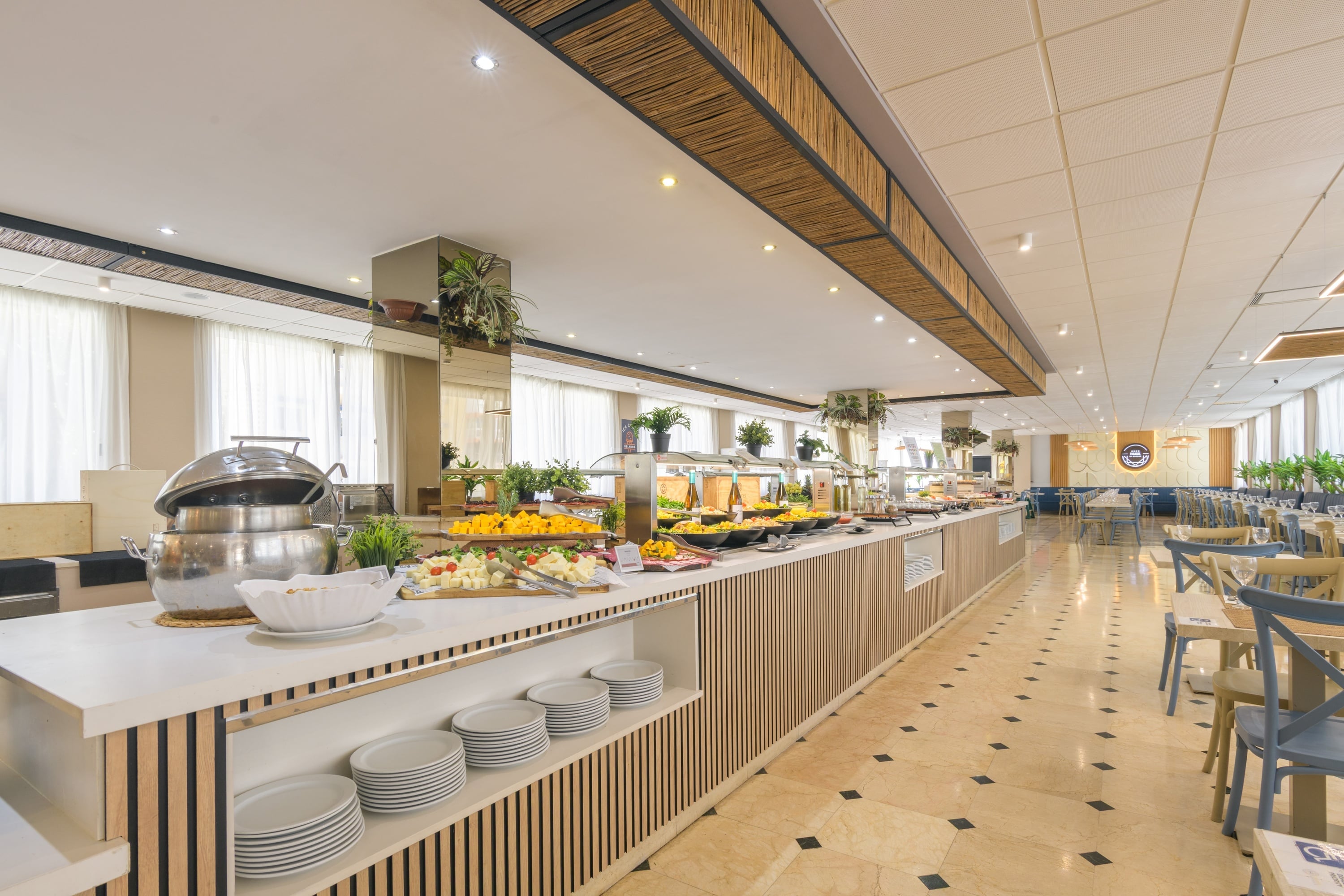 a buffet line in a restaurant with plates and a microwave