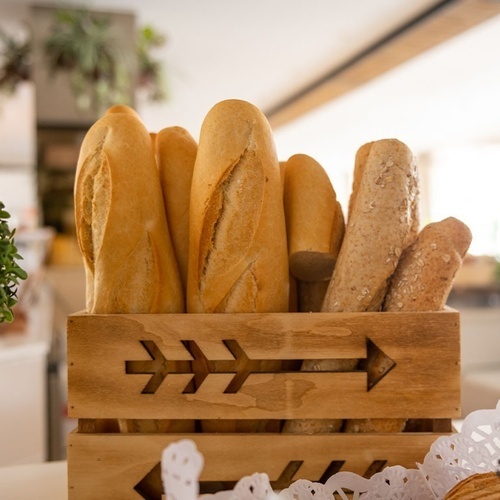 a wooden box filled with bread has an arrow carved into it